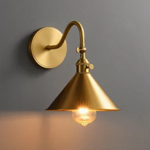 Valmont wall sconce close-up adjustable tilt knob glowing bulb detail