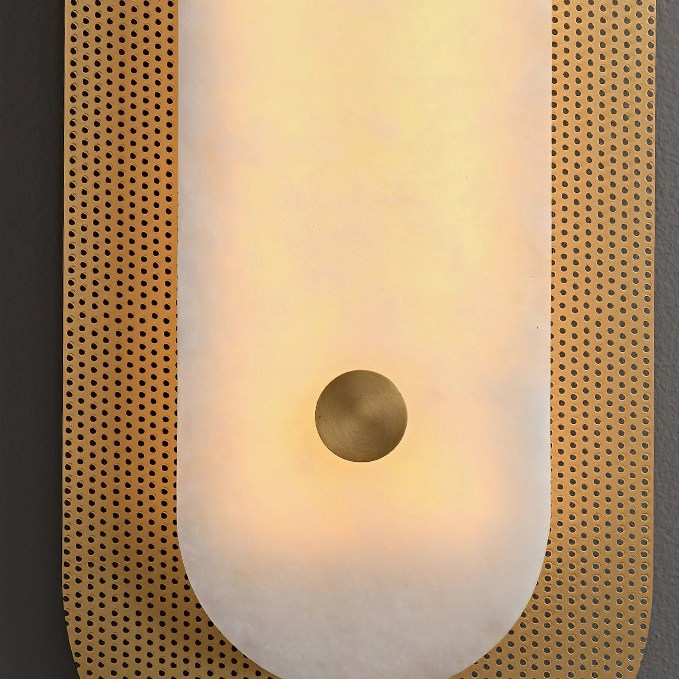 Close-up detail of Vance Wall Sconce perforated brass trim and frosted alabaster center section