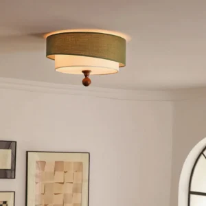 Vanelia ceiling lamp installed overhead in vintage living room, low-angle ceiling view showing warm ambient lighting, cream inner diffuser, and carved wooden decorative finial