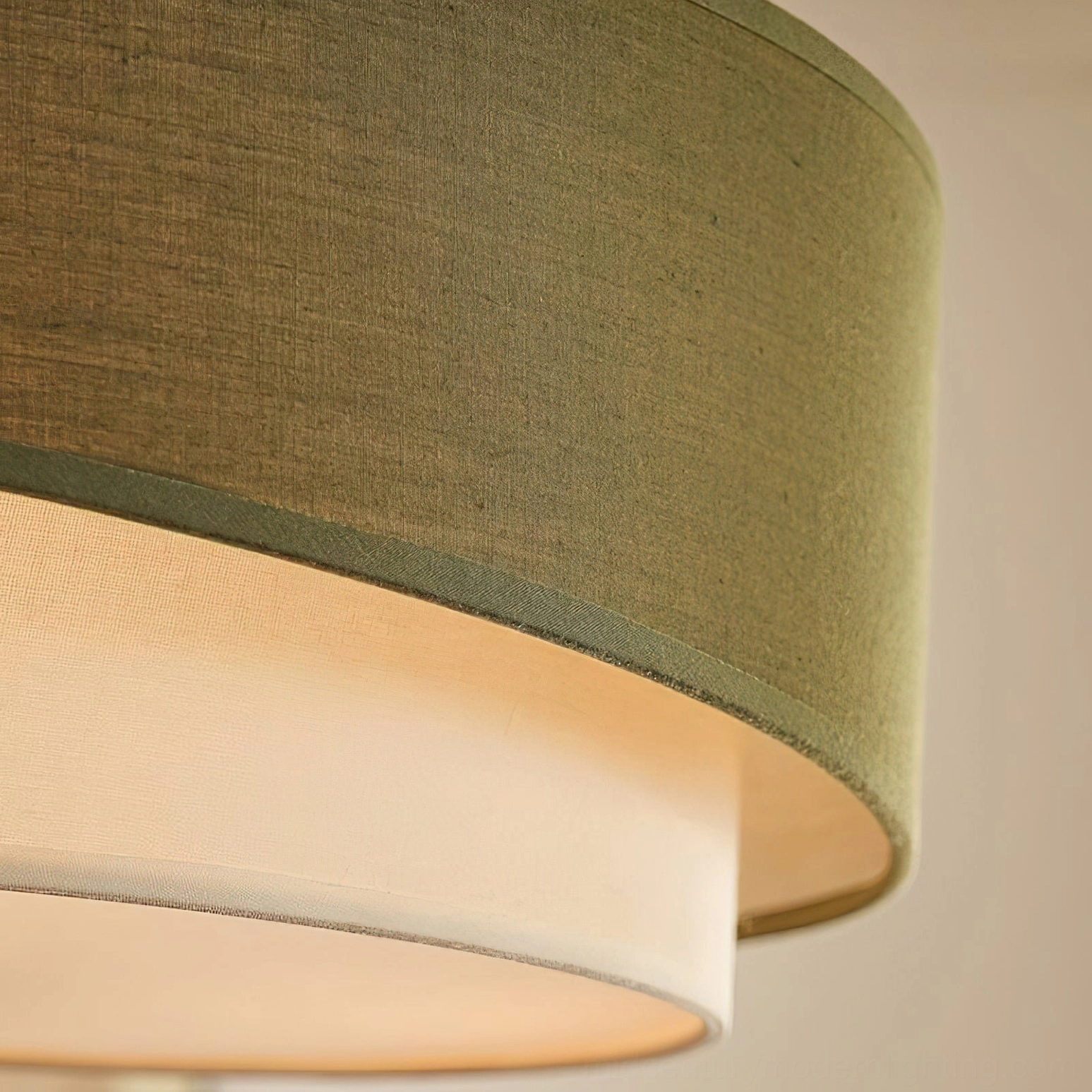 Close-up macro detail of Vanelia ceiling lamp shade showing woven linen texture, layered construction with olive green outer fabric and cream inner diffuser
