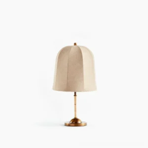 Vanna mid-century modern table lamp with brass base and cloche linen shade, studio front view on white background
