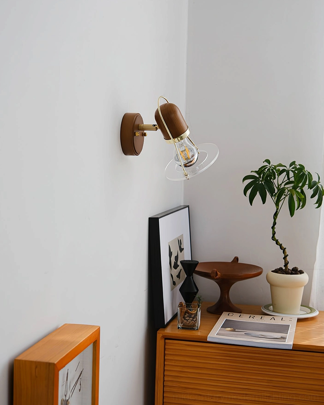 Vaughan wall sconce in living room corner with potted plants and wall art gallery display