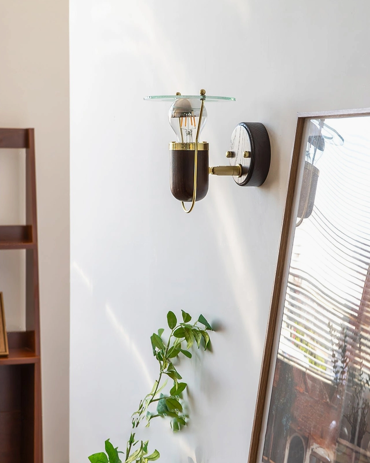 Vaughan mid-century wall sconce left side view showing walnut wood grain and brass hardware details