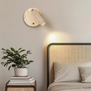 Veda travertine wall lamp installed in modern bedroom with rattan headboard creating warm accent lighting