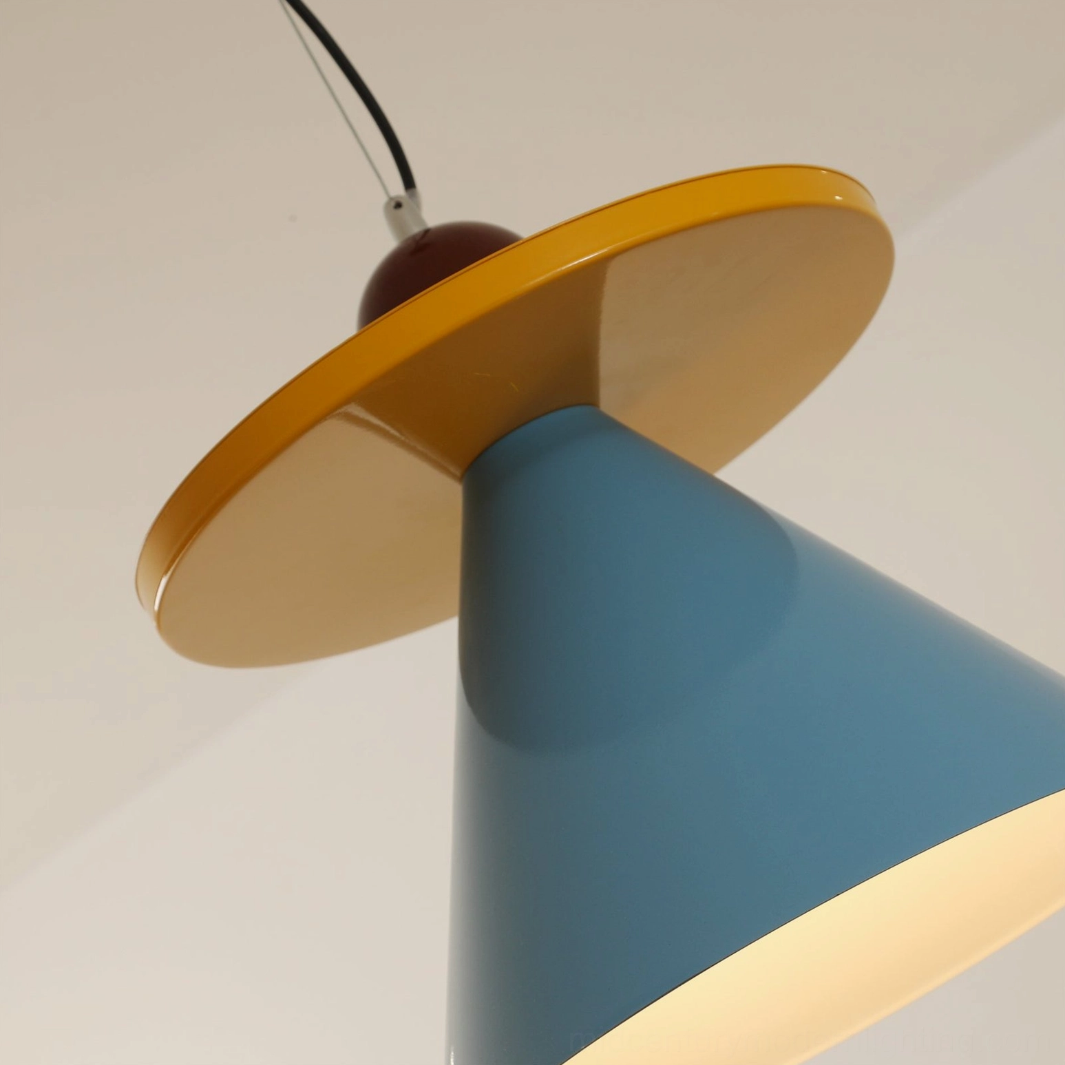 Veepee pendant lamp showing warm light glow and cone shade geometric silhouette in home interior setting