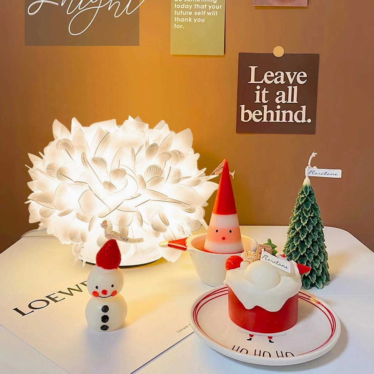 Illuminated Veli Foliage lamp on holiday desktop with Christmas ornaments warm backdrop