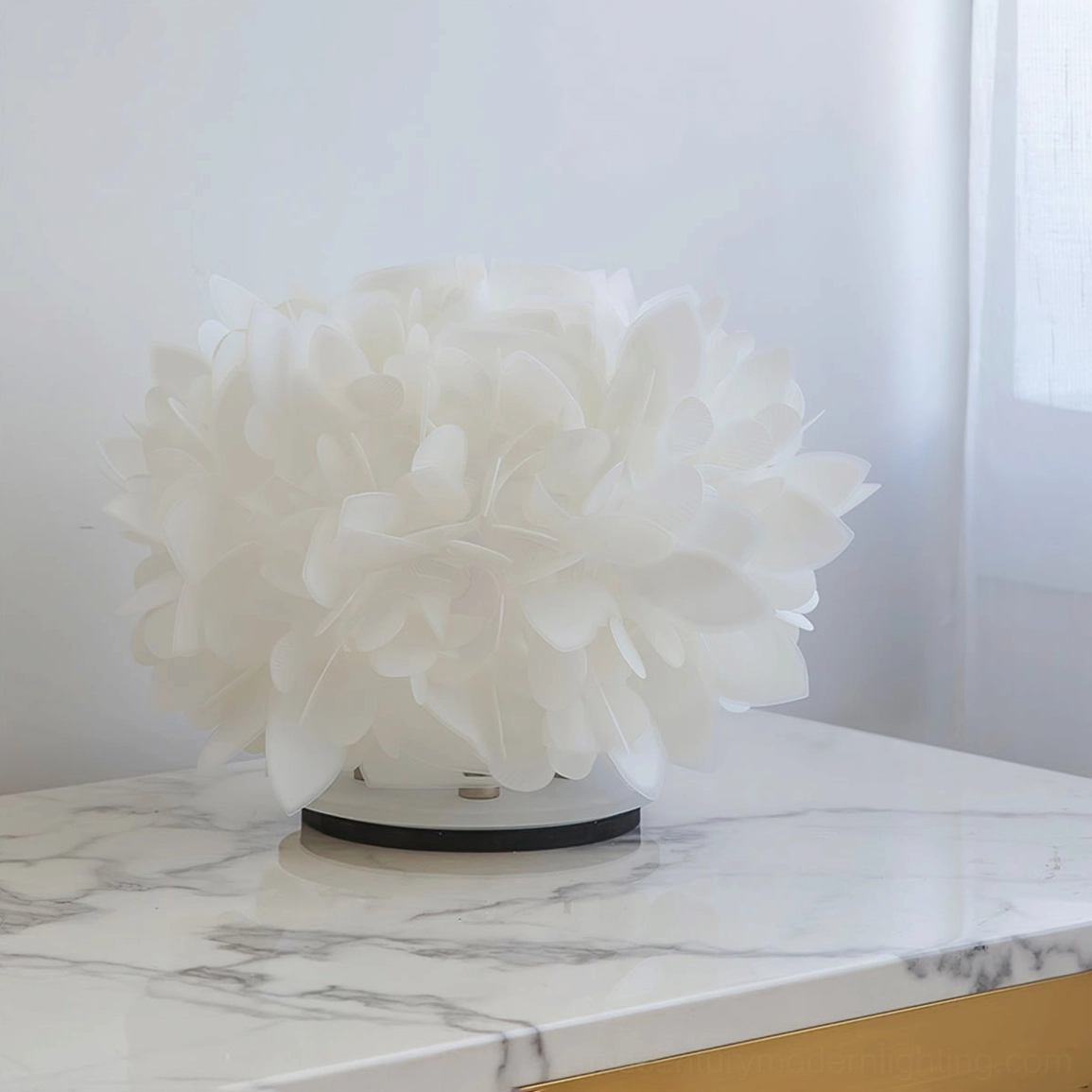 Unlit Veli Foliage white petal lamp with black base on marble countertop interior space