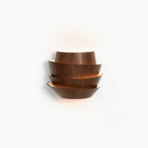 Veneer layered wall lamp frontal studio view with warm backlit glow showcasing tiered wood grain metal design