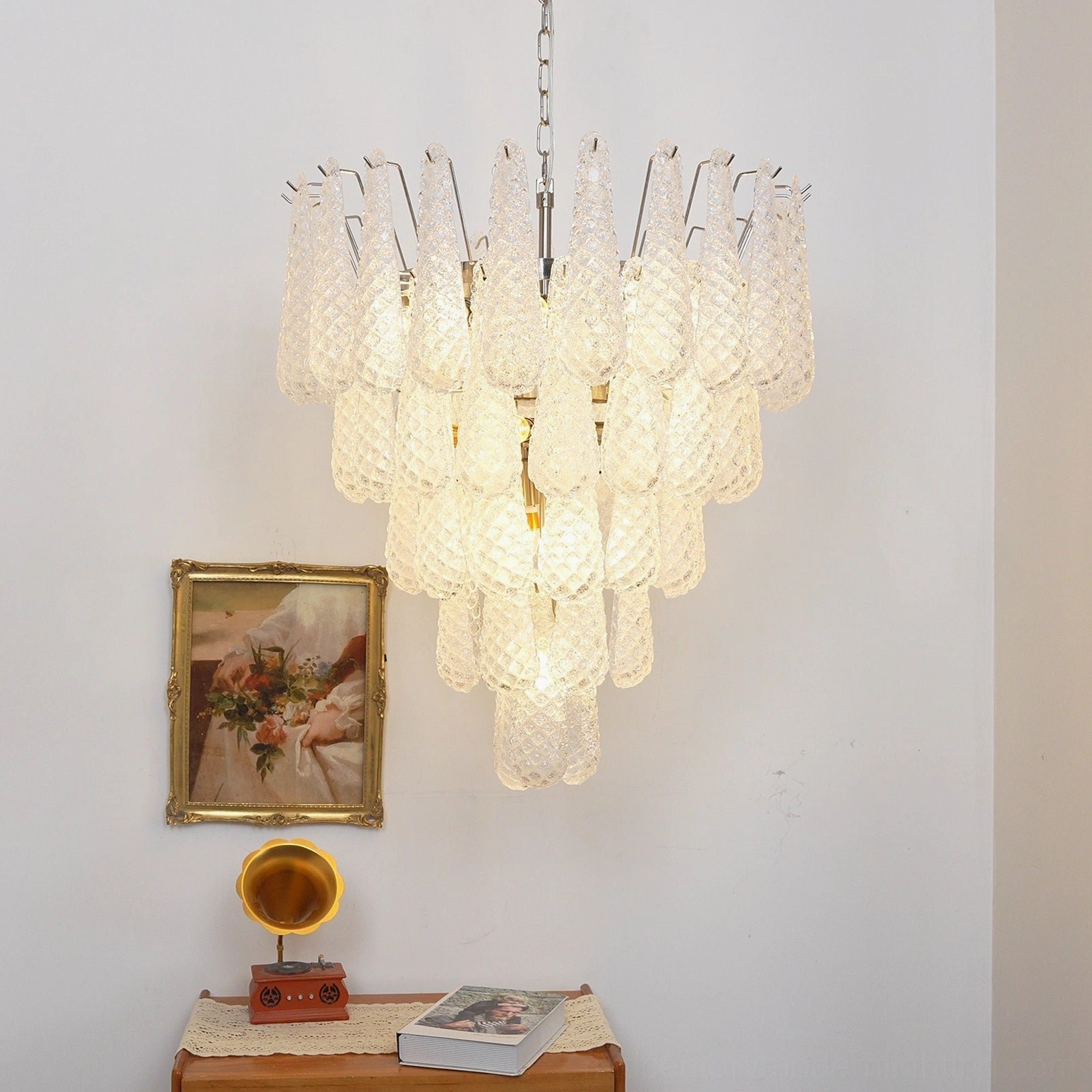 Multi-tiered Murano glass chandelier emitting soft warm light in vintage home decor corner with traditional aesthetic