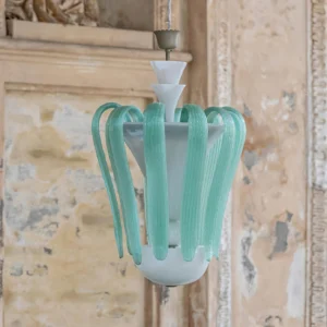 Venini art glass chandelier three-quarter angle view showing frosted mint-green curved glass bands on vintage stone wall interior