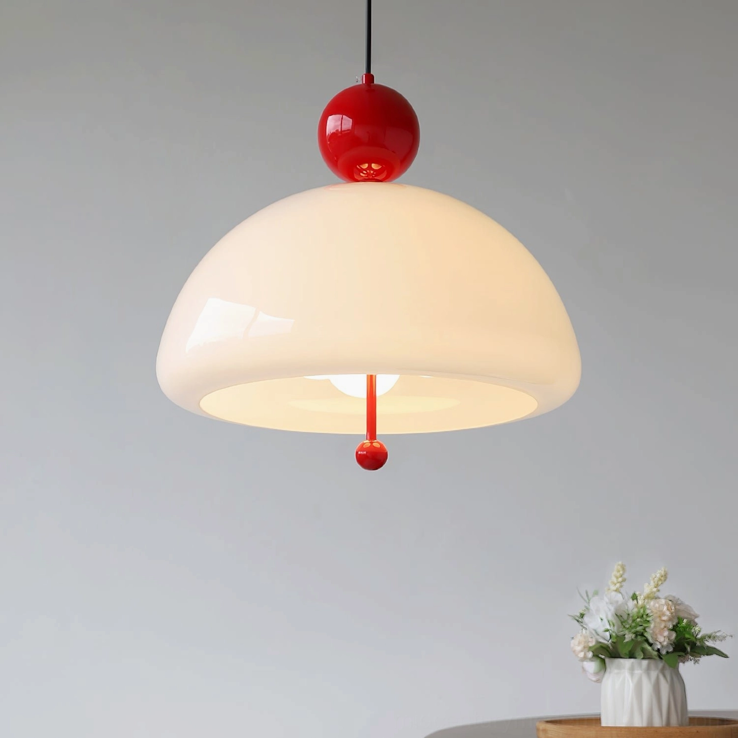 Verona pendant light installed in modern home interior with minimalist side table and floral arrangement