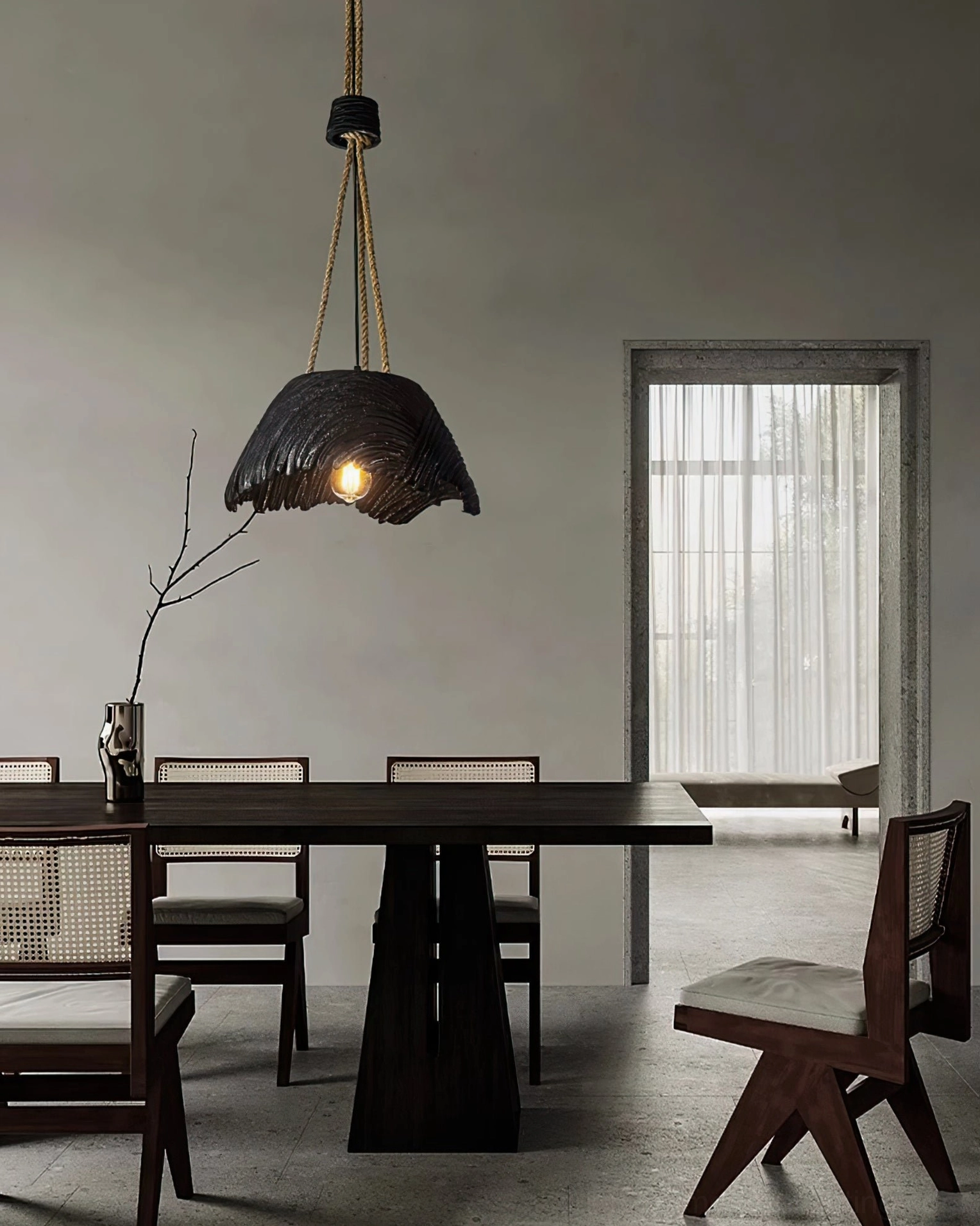 Viana wabi-sabi pendant light installed in minimalist modern dining room above dark table