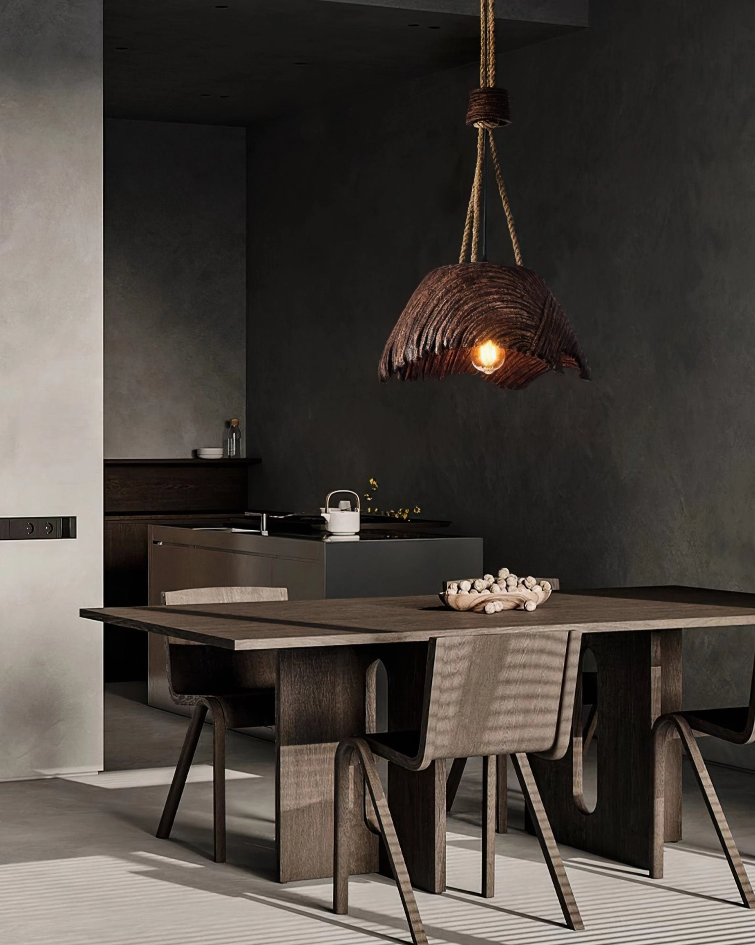 Viana rope pendant with warm ambient glow in dark tone kitchen dining area above wooden furniture