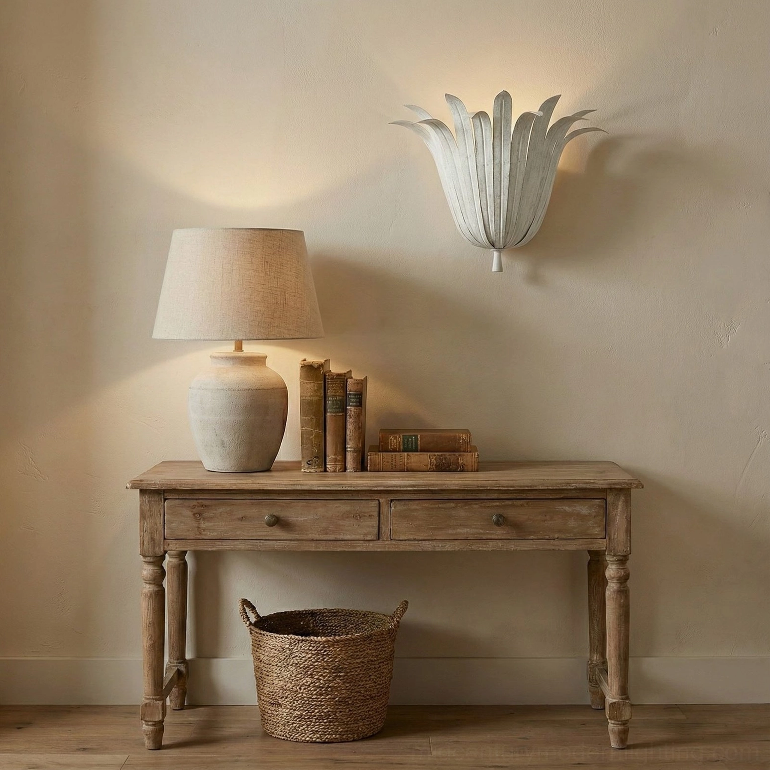Pair of off-white Vicenzio leaf sconces installed above rustic wooden console table in neutral entryway with woven storage