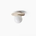 Victor travertine ceiling light pendant fixture, unlit, showing beige stone base with fluted scalloped detailing and opal glass globe, minimalist design studio photography