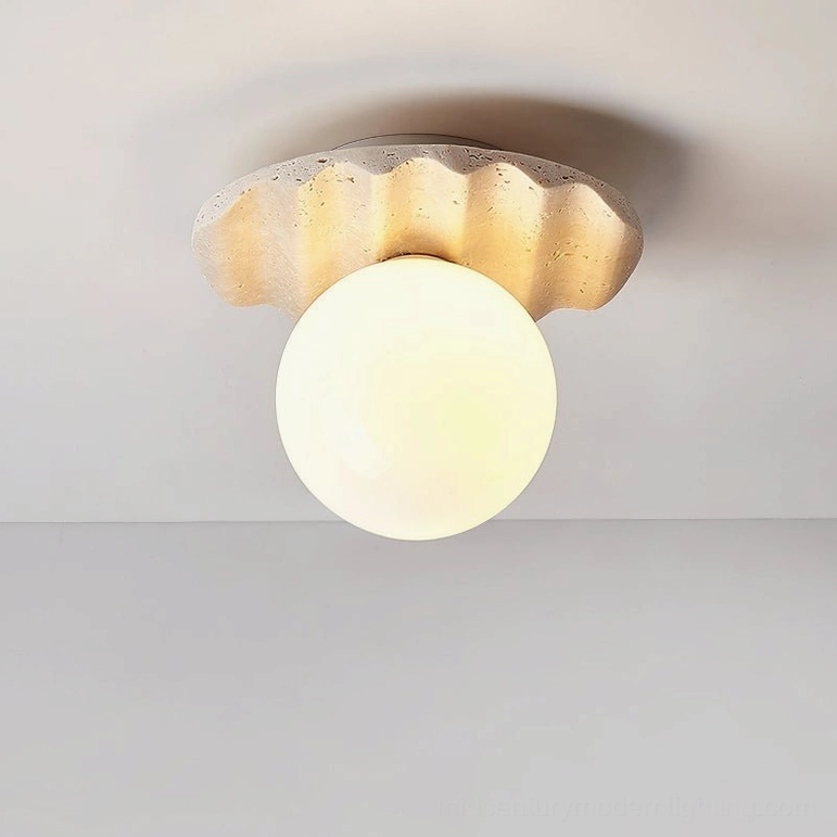 Victor ceiling light fixture illuminated, warm glowing bulb, ridged travertine base with soft shadow cast, mid-century modern pendant design studio view
