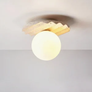 Victor ceiling light illuminated, warm glow emanating from opal glass, travertine base with visible fluting details, soft light diffusion overhead view