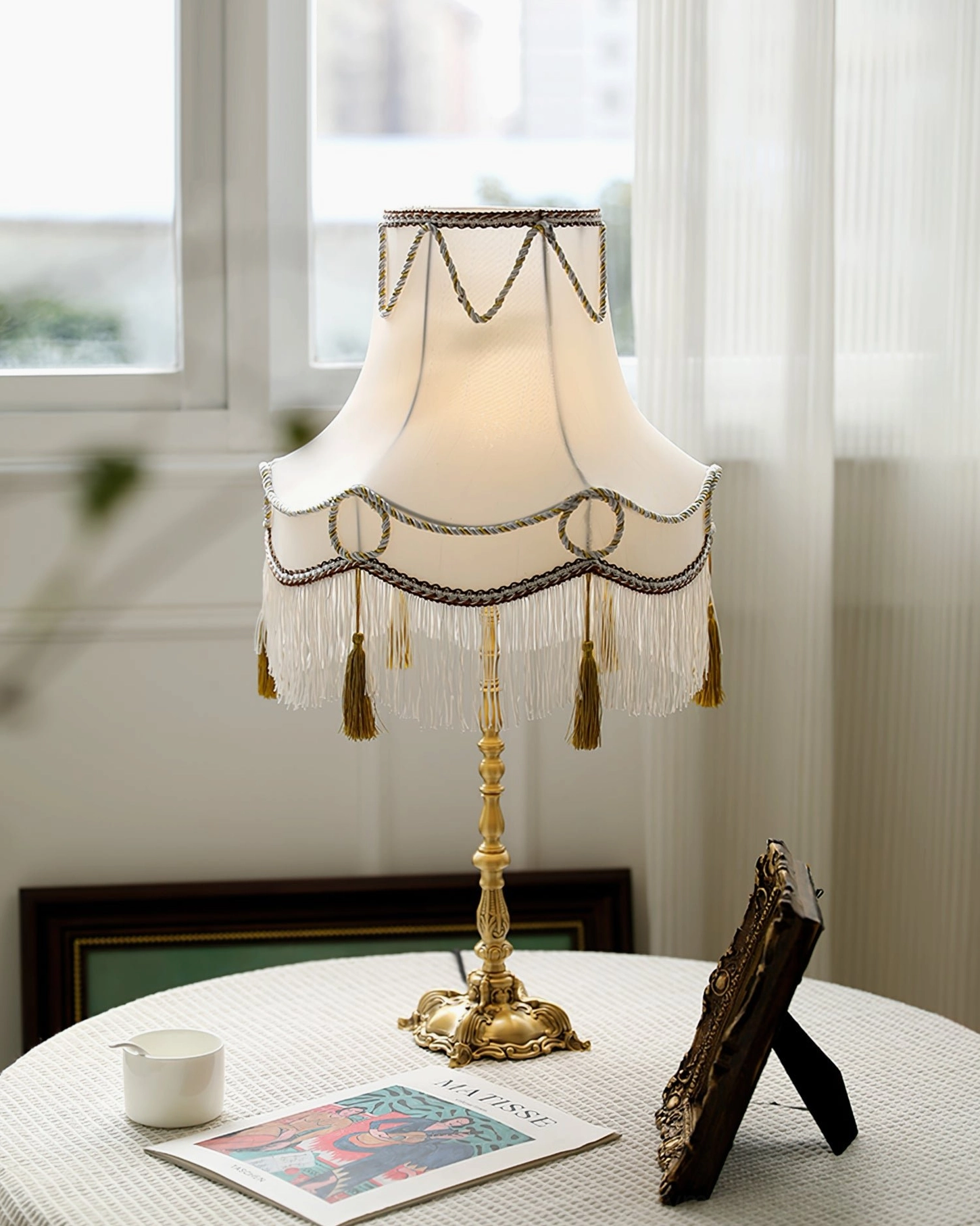 Victorian brass table lamp with delicate fabric shade and ornamental brass base detail