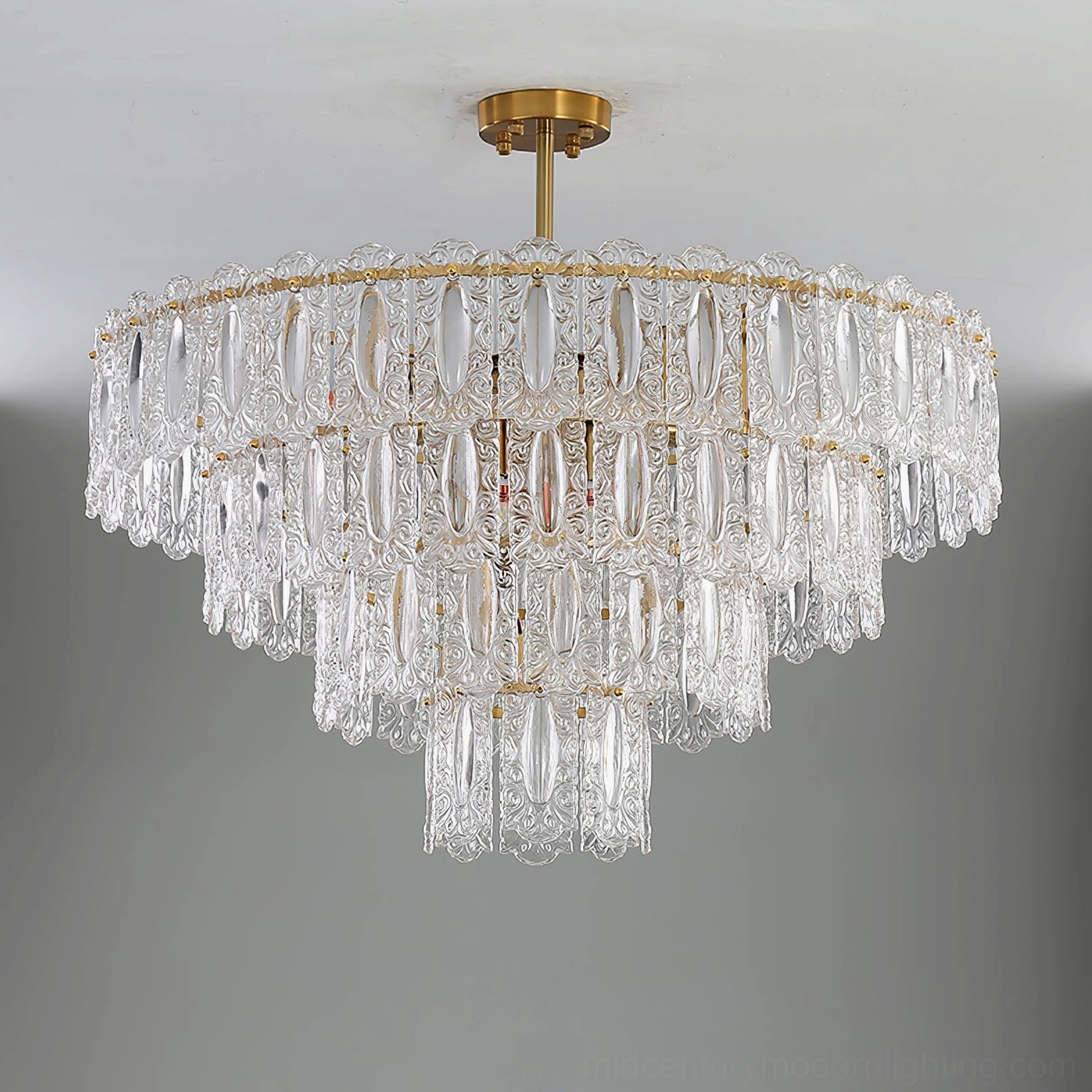 Vienna layered crystal chandelier with transparent glass petals and gold hardware on gray background