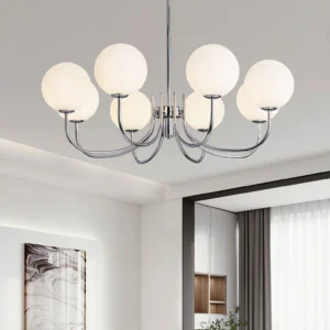 Vierra 8-light globe chandelier installed in modern living room with marble wall art, chrome frame with soft white glass diffusers