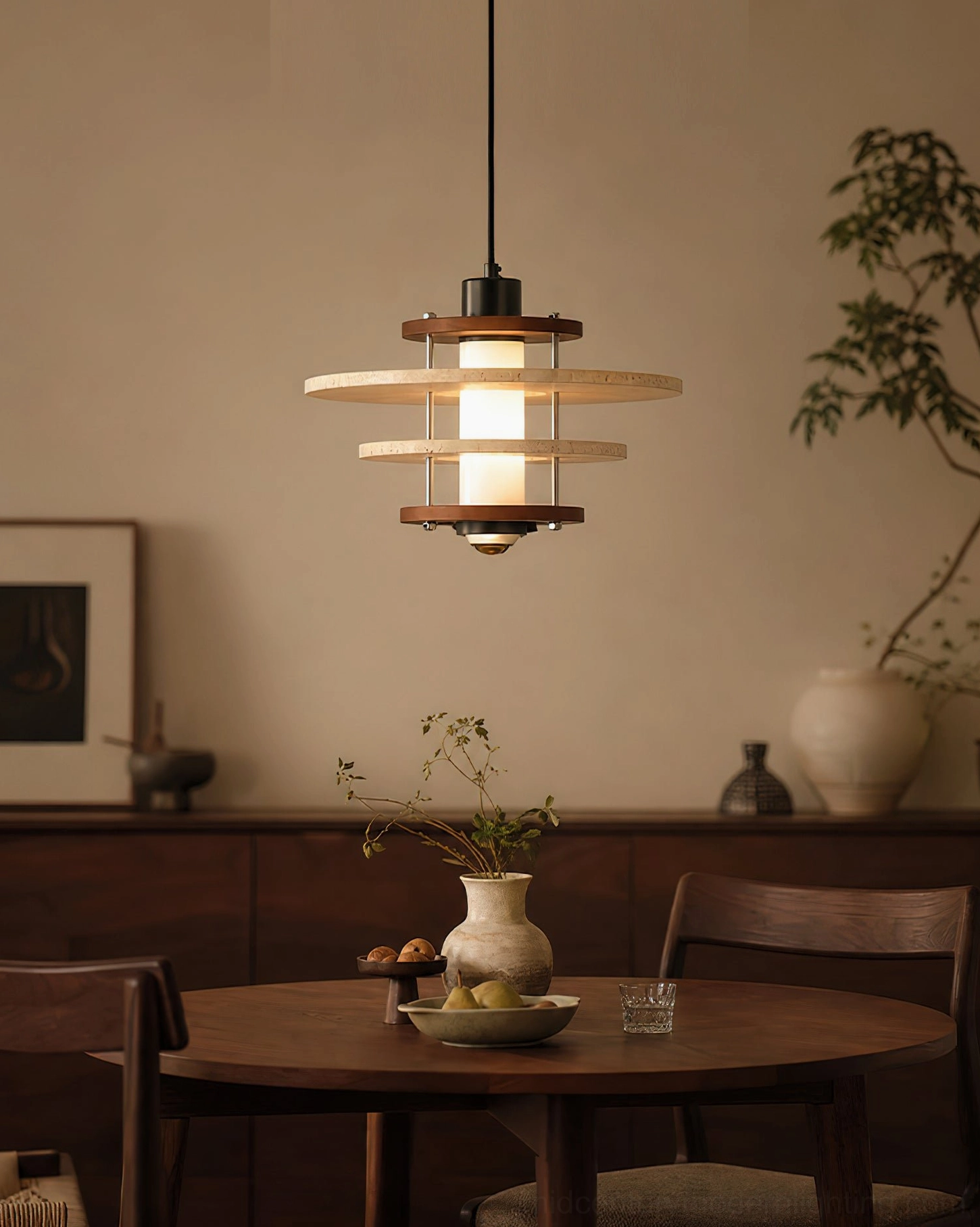 Minimalist neutral dining room with layered travertine pendant lamp creating cozy warm home decoration lighting