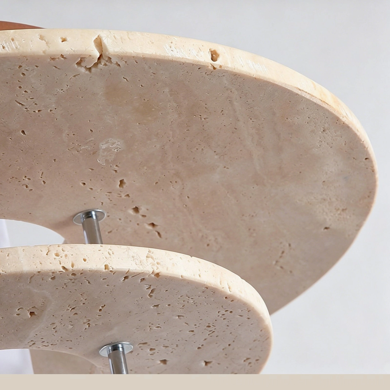 Flat bottom view of Vigo travertine pendant showing porous natural stone texture and round stone discs material composition
