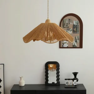 Handwoven rattan pendant light hanging in vintage entryway with black console table and arched wall decor, boho rustic interior styling
