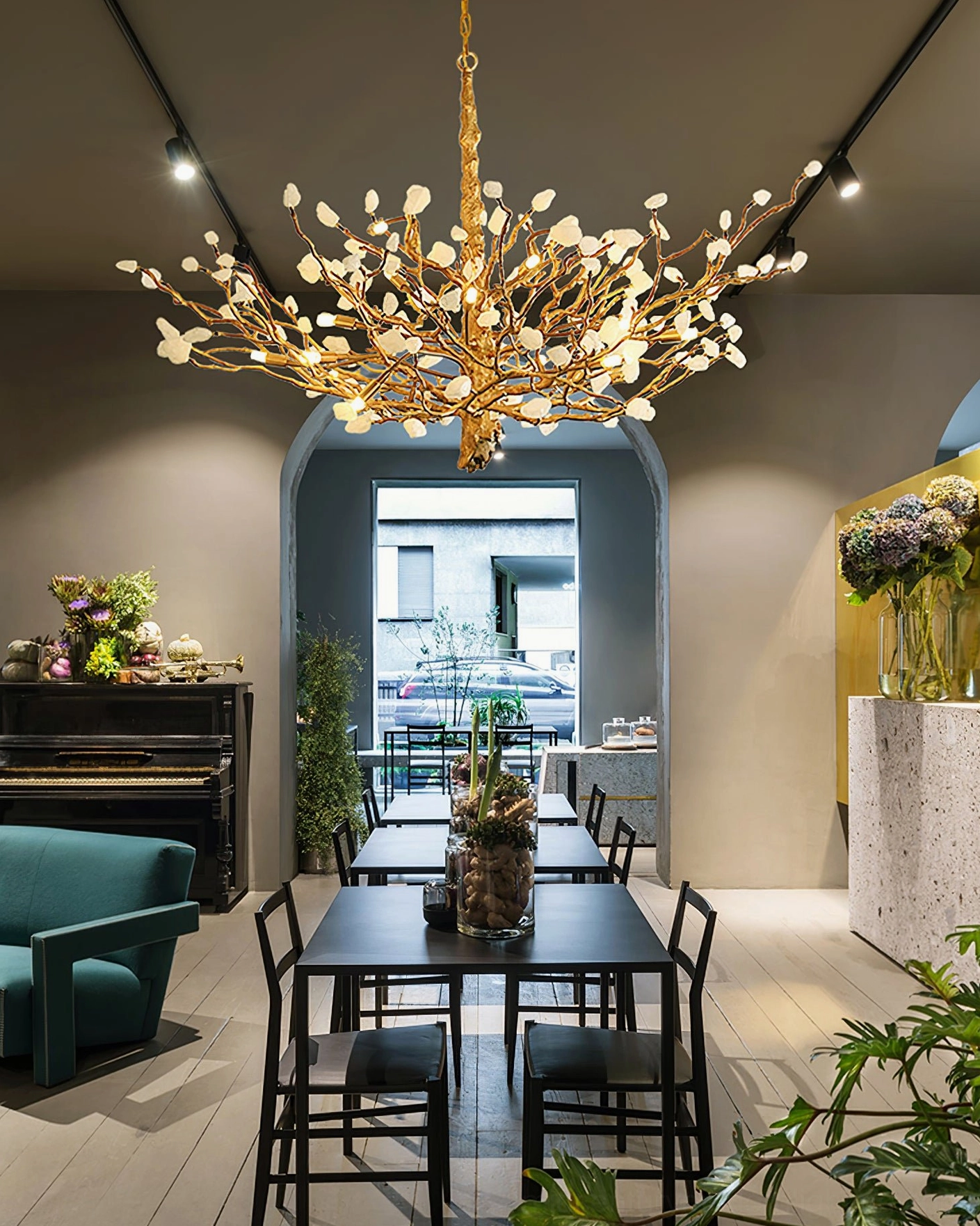 Vintage residential dining space ceiling with brass gemstone chandelier warm ambient lighting