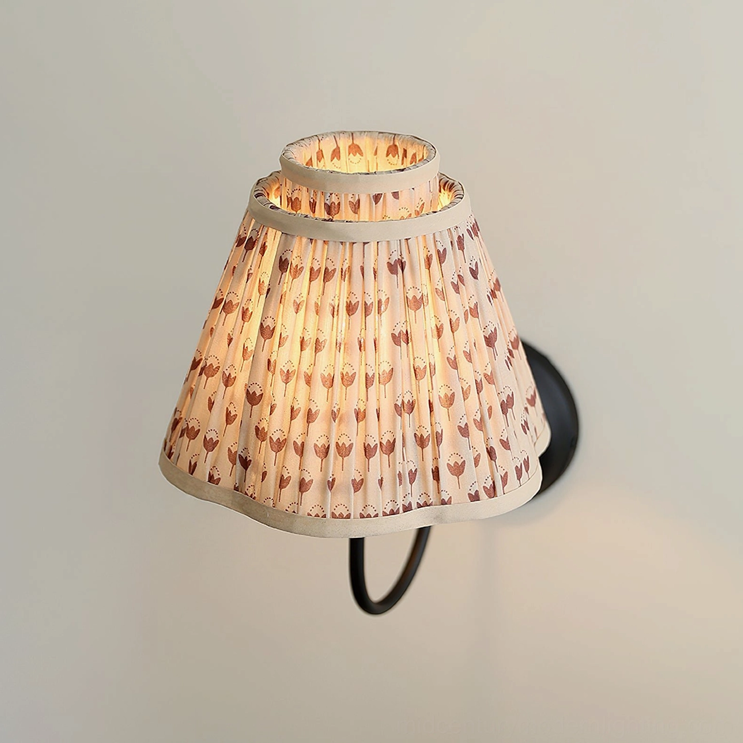Vintage-inspired elbow wall lamp with pleated fabric shade, close-up product shot
