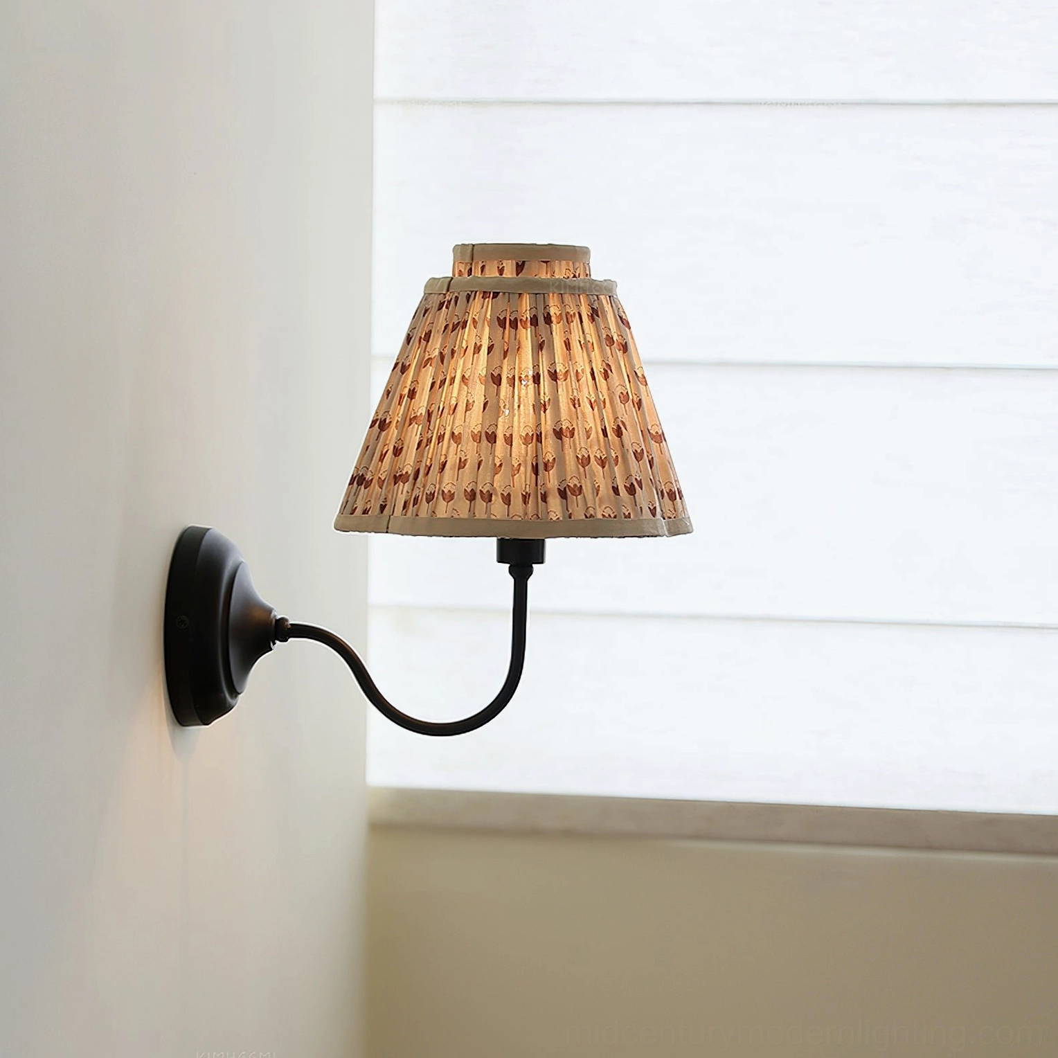 Vintage-style elbow wall lamp with brown pleated shade and black curved bracket, side profile