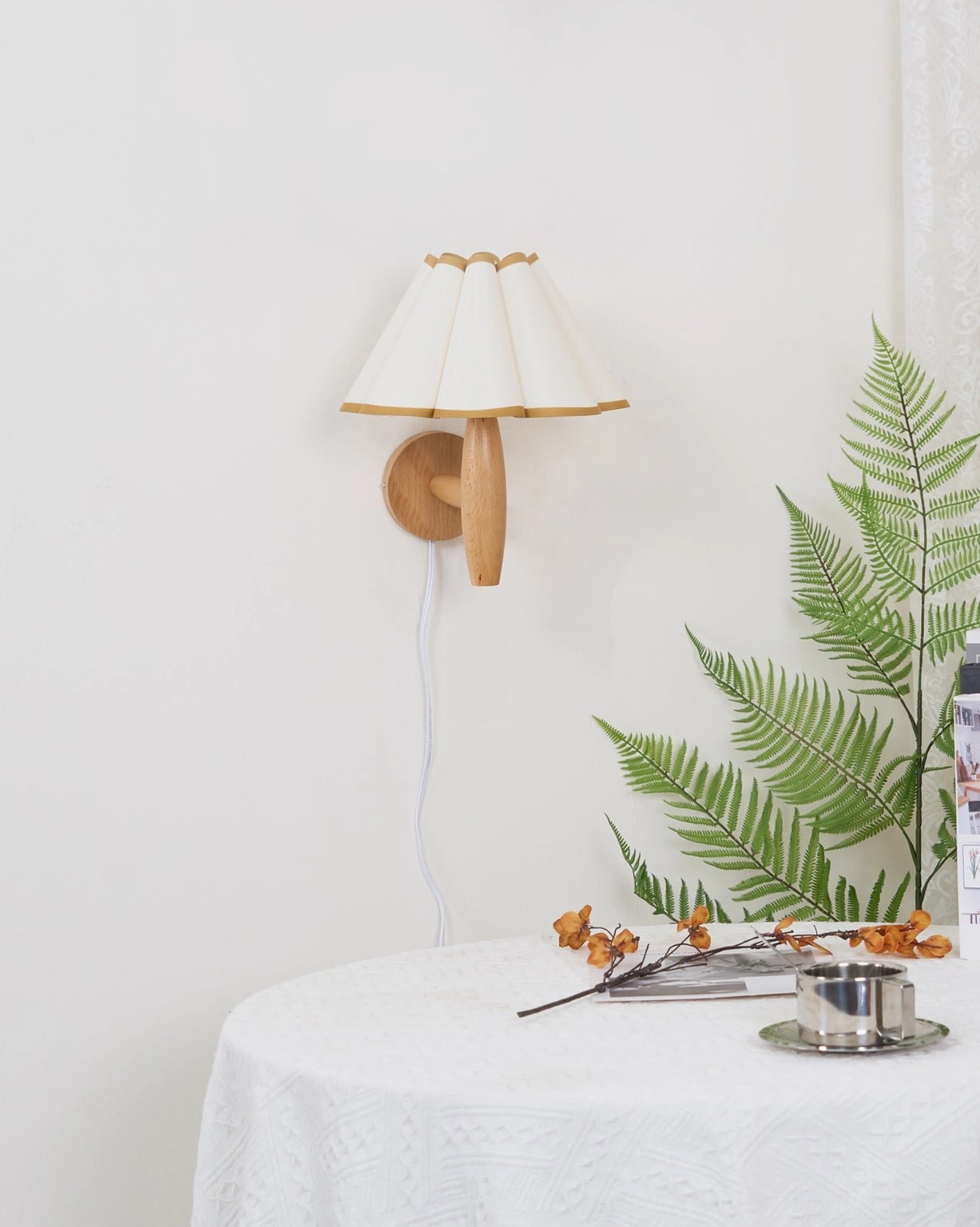 Vintage fluted plug-in wall lamp with white and yellow pleated shade in bedroom nook setting