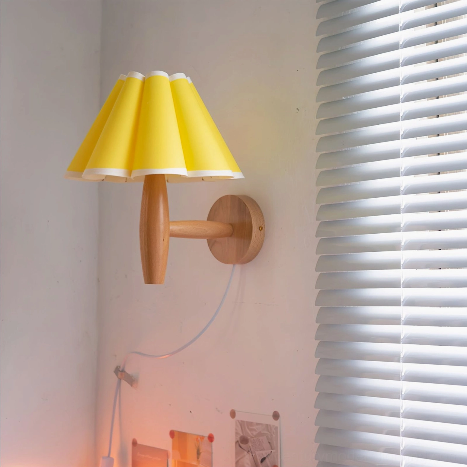 Vintage fluted wall lamp in bedroom setting with window blinds, yellow pleated shade glowing