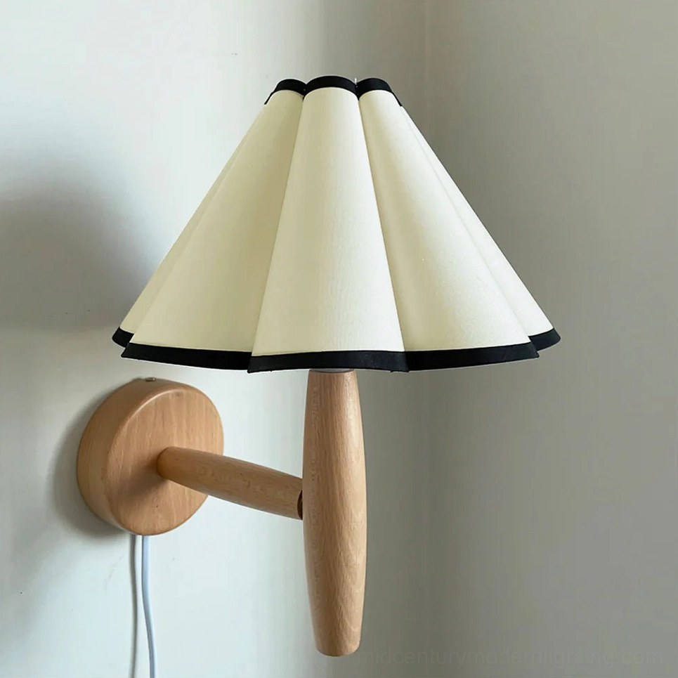 Vintage fluted plug-in wall lamp with beige and black pleated shade on interior wall