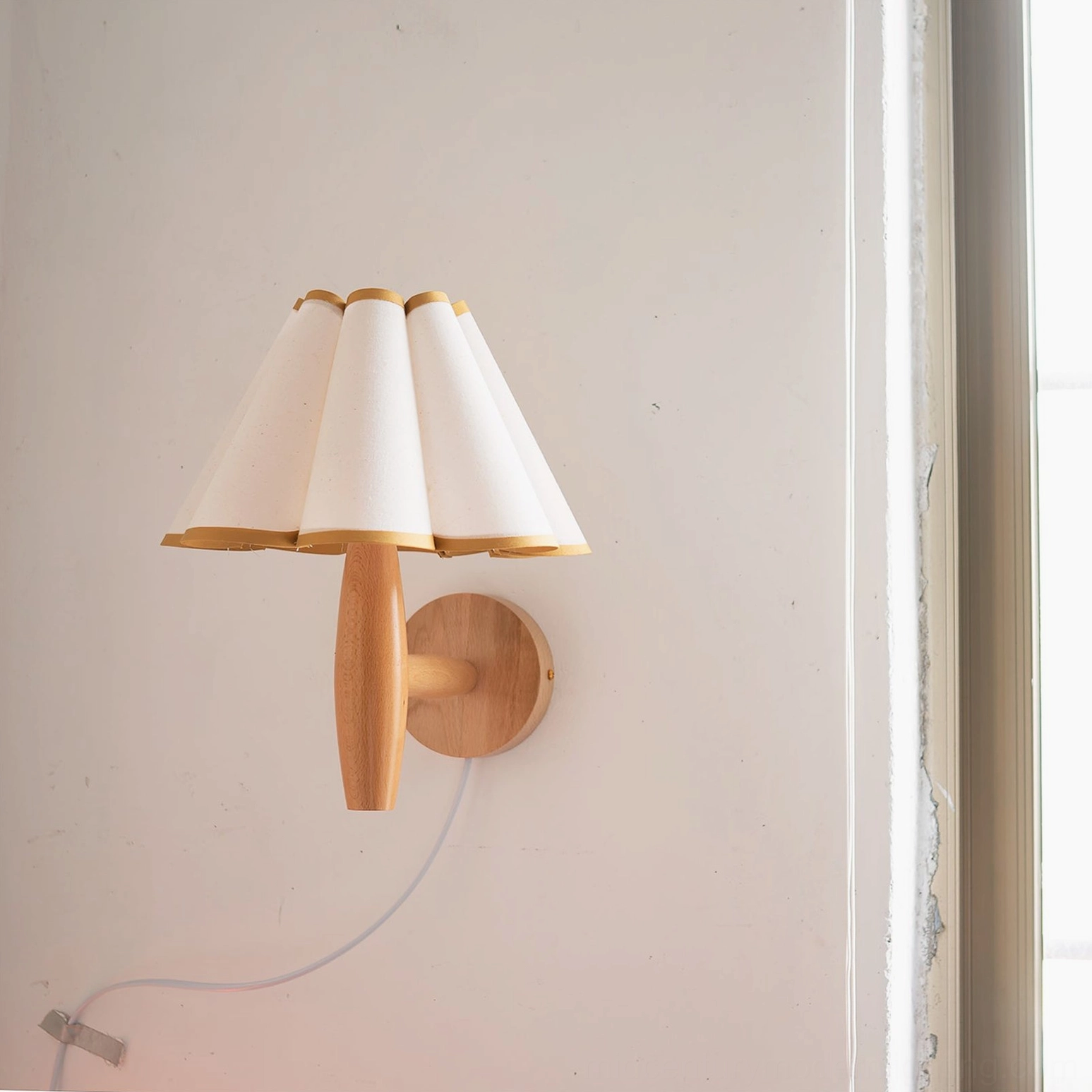 Mid-century modern fluted wall lamp with warm light diffusion from pleated fabric shade