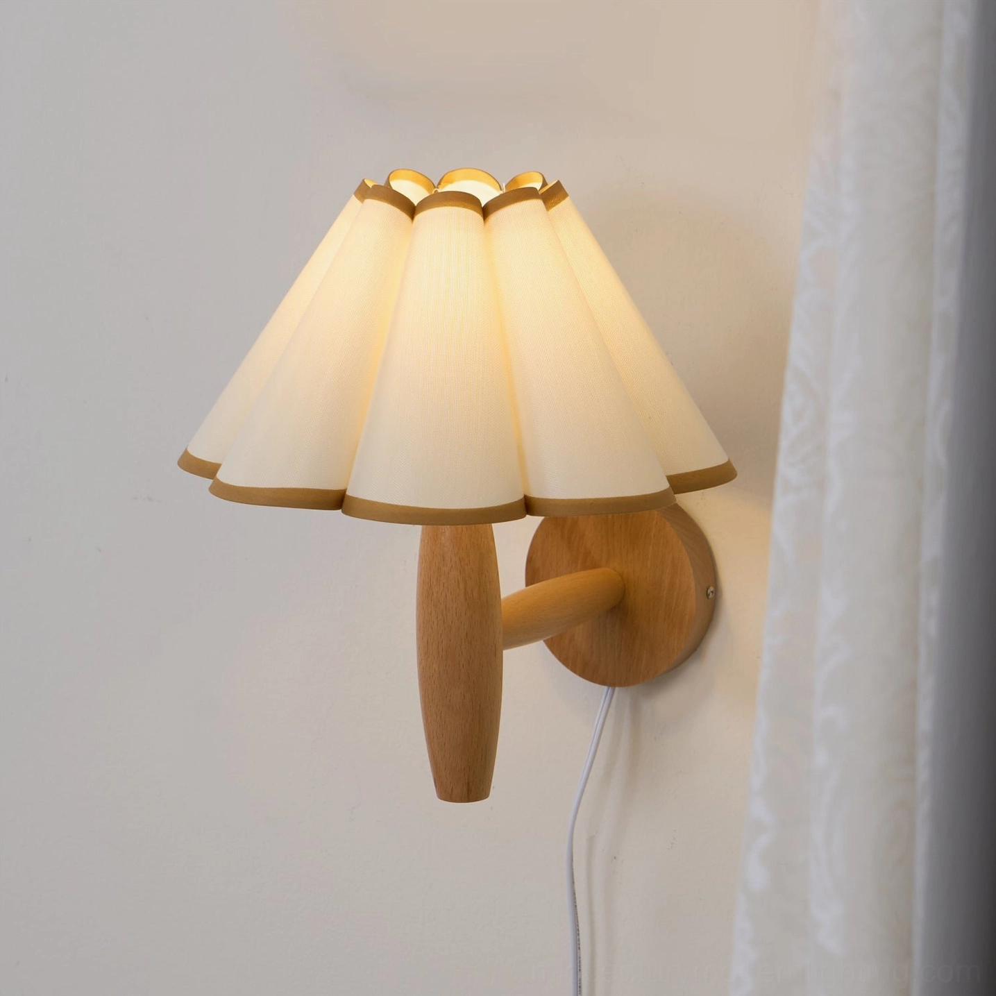 Side view of vintage fluted plug-in wall lamp with white pleated shade and power cord