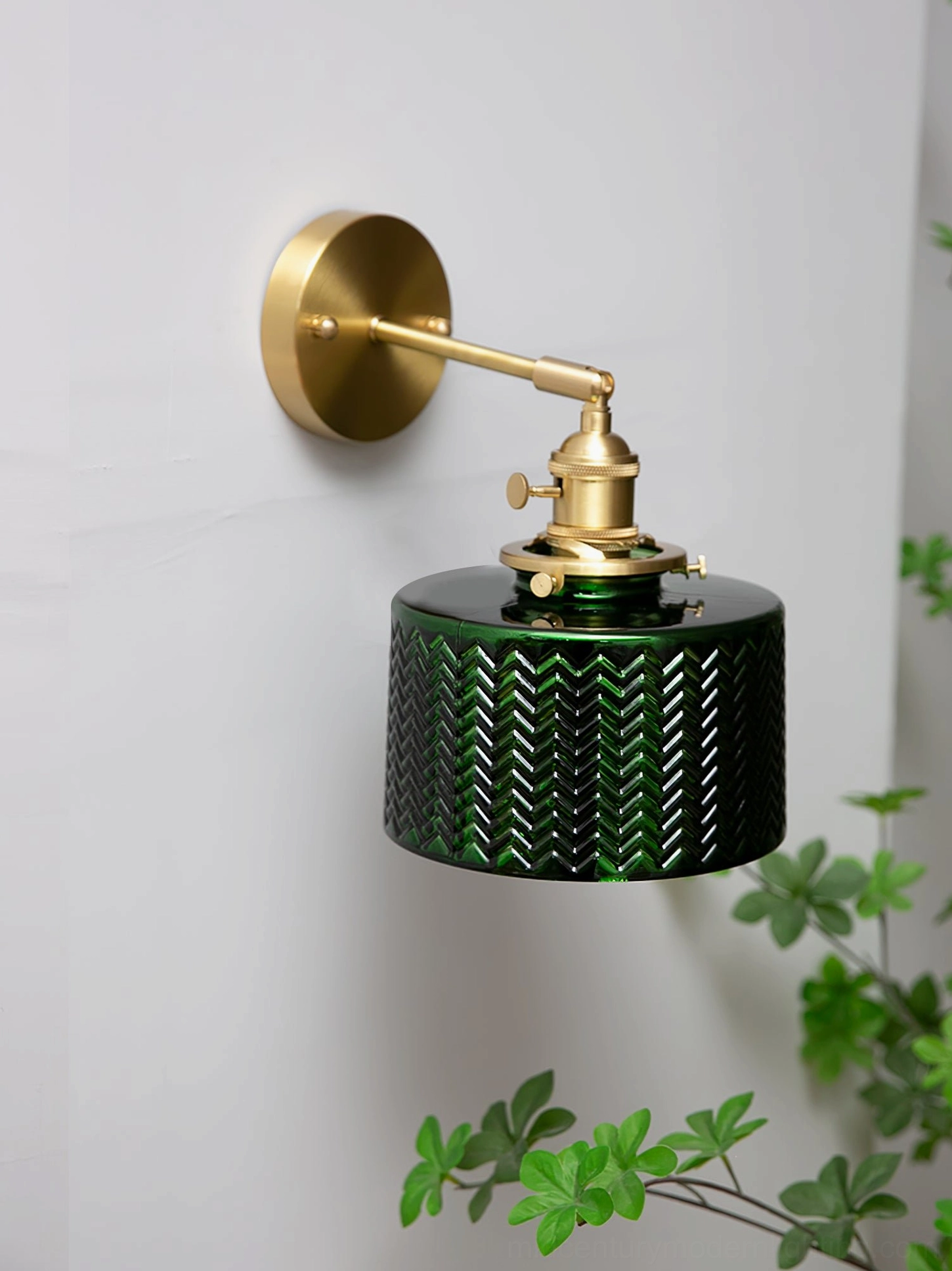 Vintage green glass wall sconce with adjustable brass swivel arm and integrated control switch