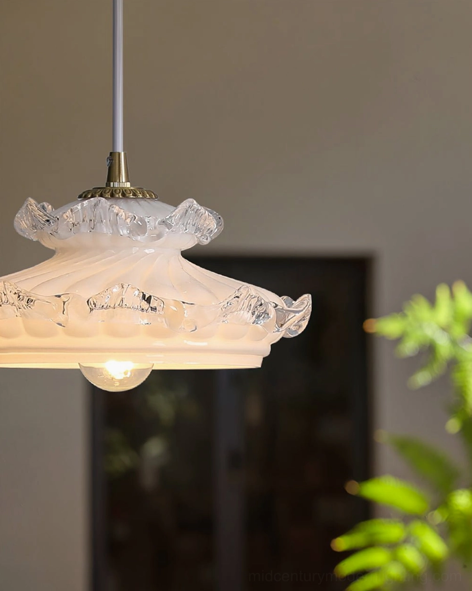 Vintage hanging pendant light with warm glowing bulb and brass top fixtures in indoor room