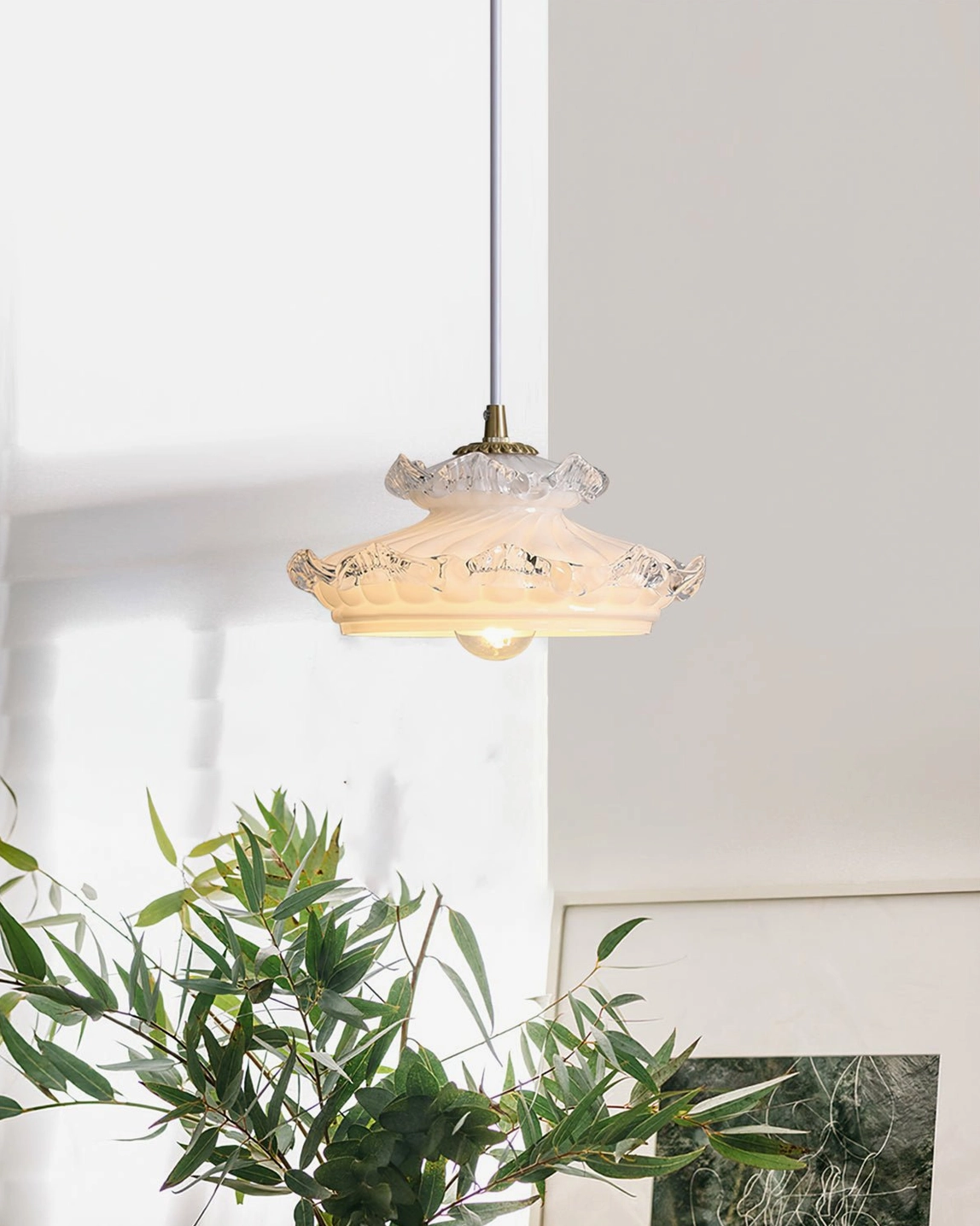 Retro ceiling pendant lamp with ruffled clear glass trim glowing in sunlit living room with green foliage