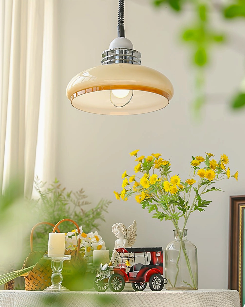 Low front view of vintage mid-century pendant lamp over decorated tabletop with yellow flowers and warm cottage home aesthetic
