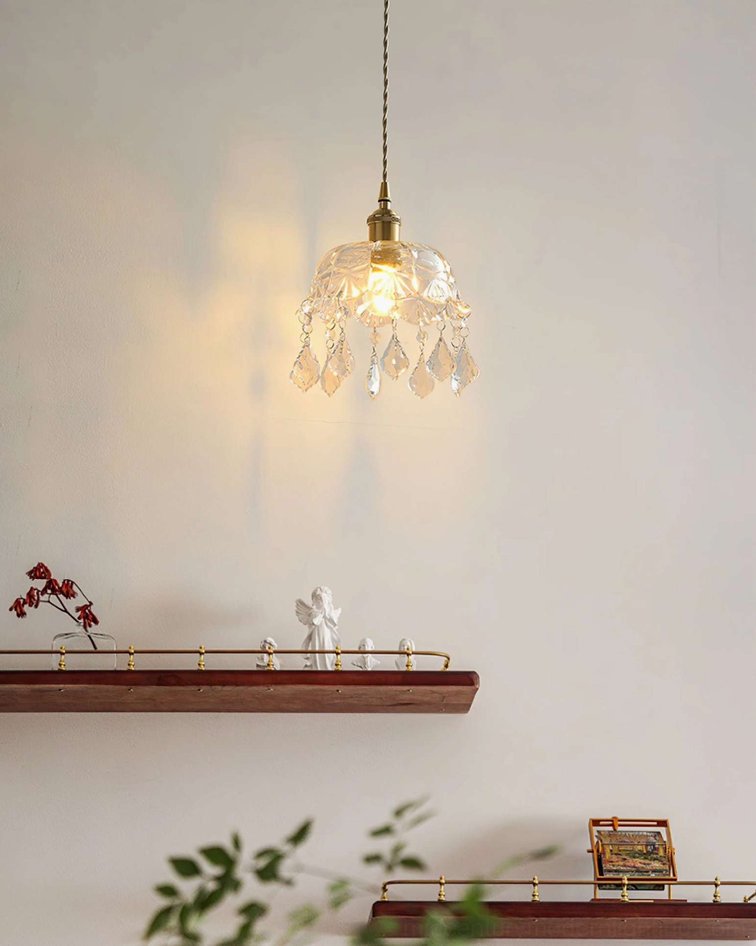 Vintage brass pendant over wooden shelving, warm wall-wash lighting effect, low angle view
