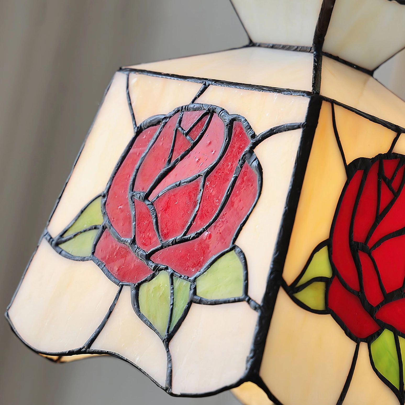 Vintage-inspired rose botanical pendant lamp featuring crimson and pink stained glass, complete product photography with warm glow