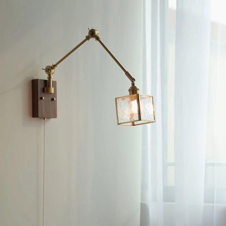 Single-arm swing wall lamp with dark walnut wood base and brass articulated arm near window, interior design setting