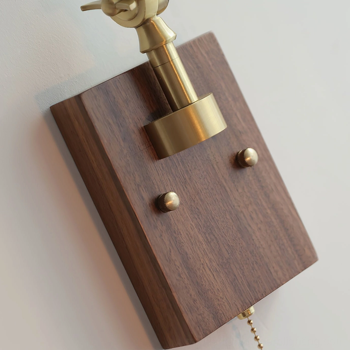 Vintage-style swing arm wall lamp with green ribbed glass shade and polished brass arms extending from dark wood wall mount