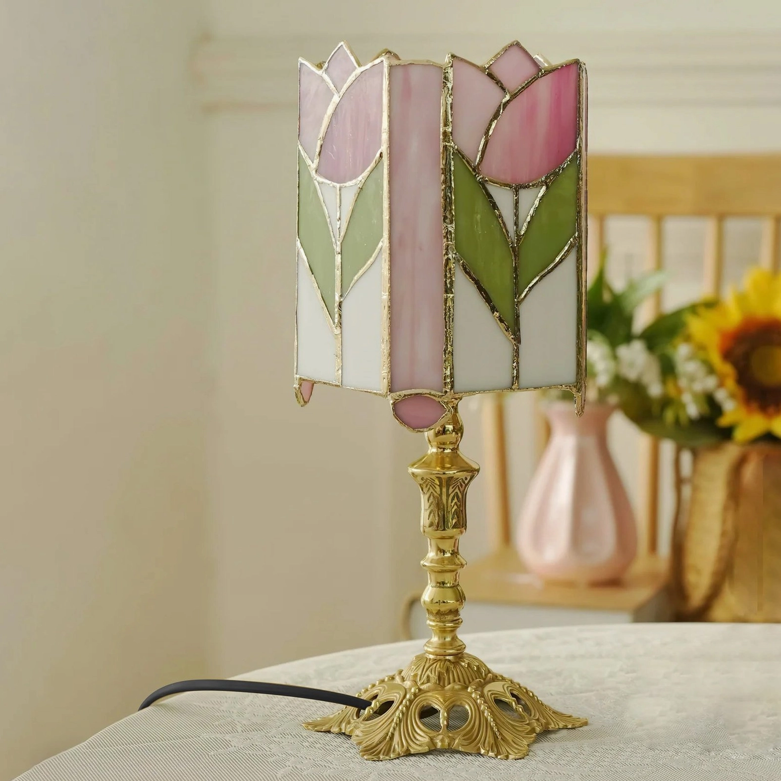 Vintage inspired tulip stained glass table lamp with pink and green tones and traditional brass casting