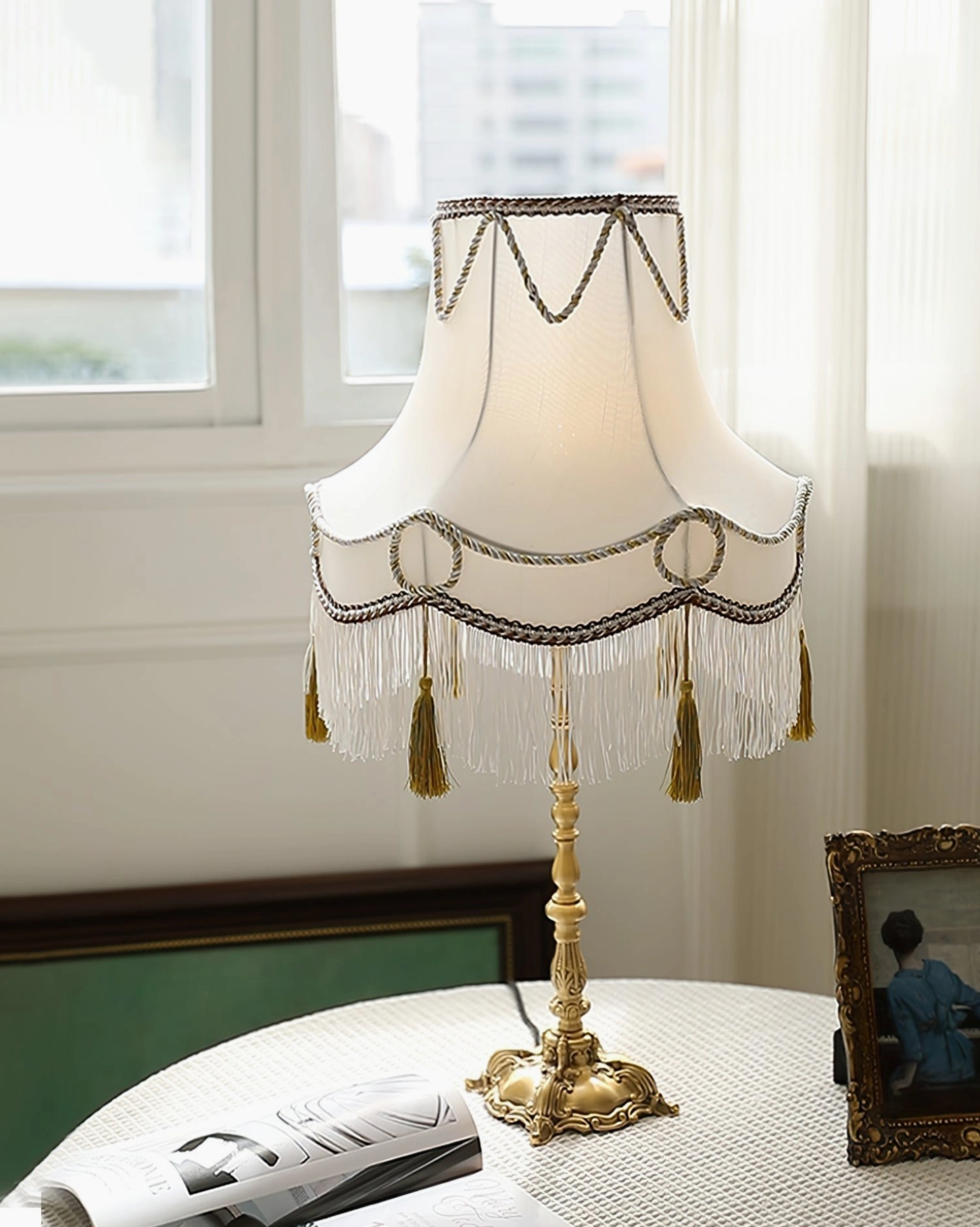 Full front view of vintage Victorian lamp with dark braided trims, golden tassels and carved brass stand