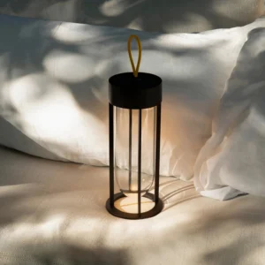 Portable Vitro LED lantern lamp on bedroom bedding creating warm ambient lighting atmosphere