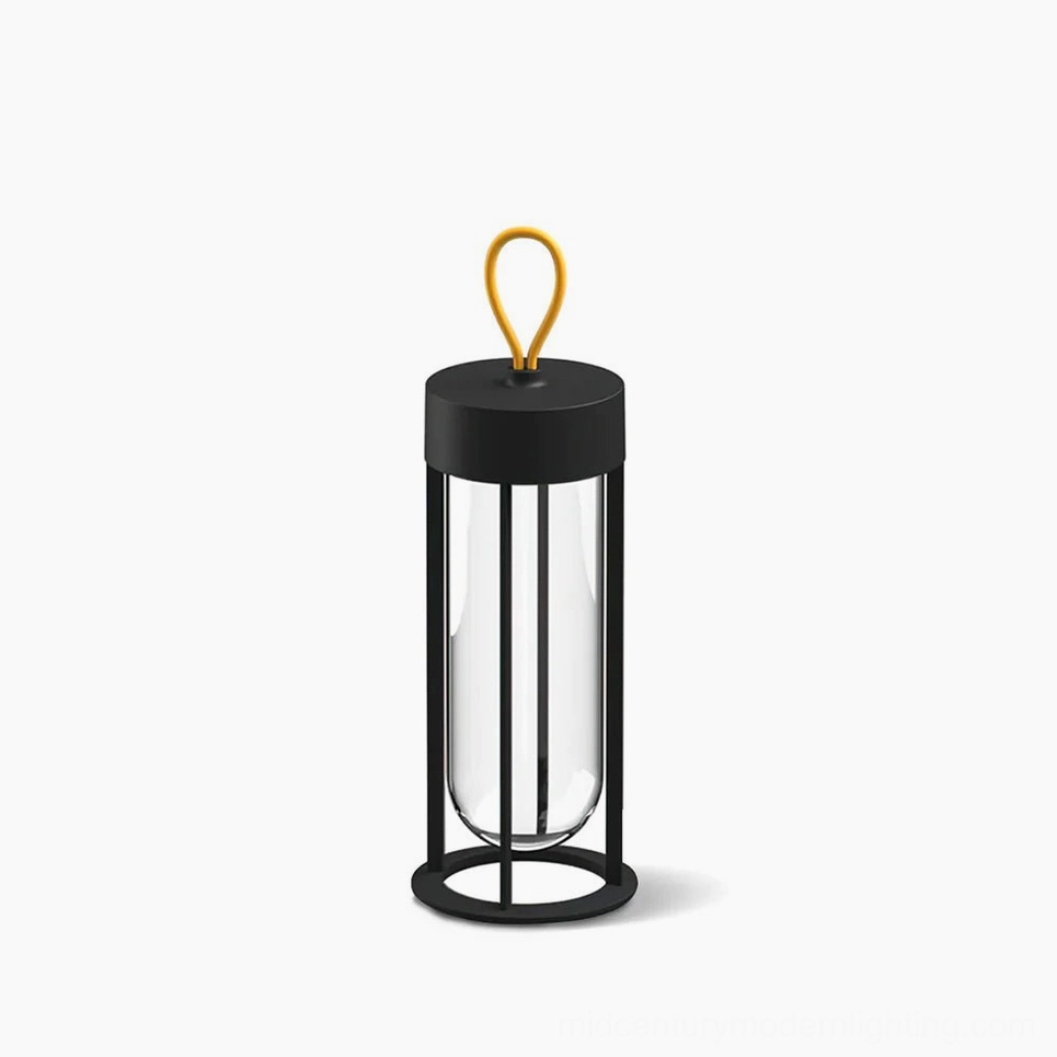 Vitro cordless LED table lamp with matte black metal frame and glass diffuser in minimalist studio setting