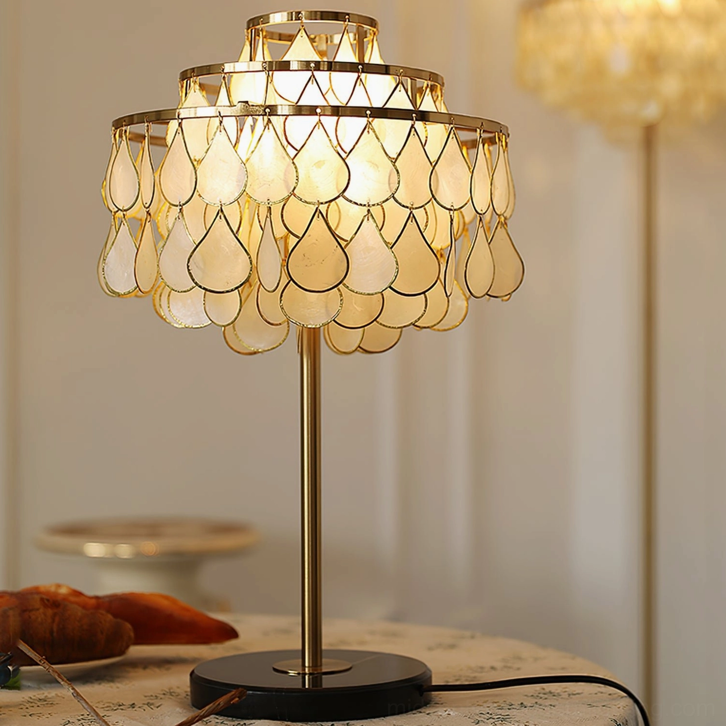 Vivant Shell Table Lamp three-quarter view glowing shell shade polished gold hardware pastry table setting
