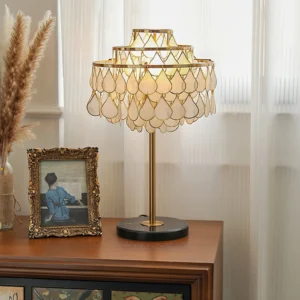 Vivant Shell Table Lamp styled on vintage wooden sideboard with warm ambient lighting and retro home décor