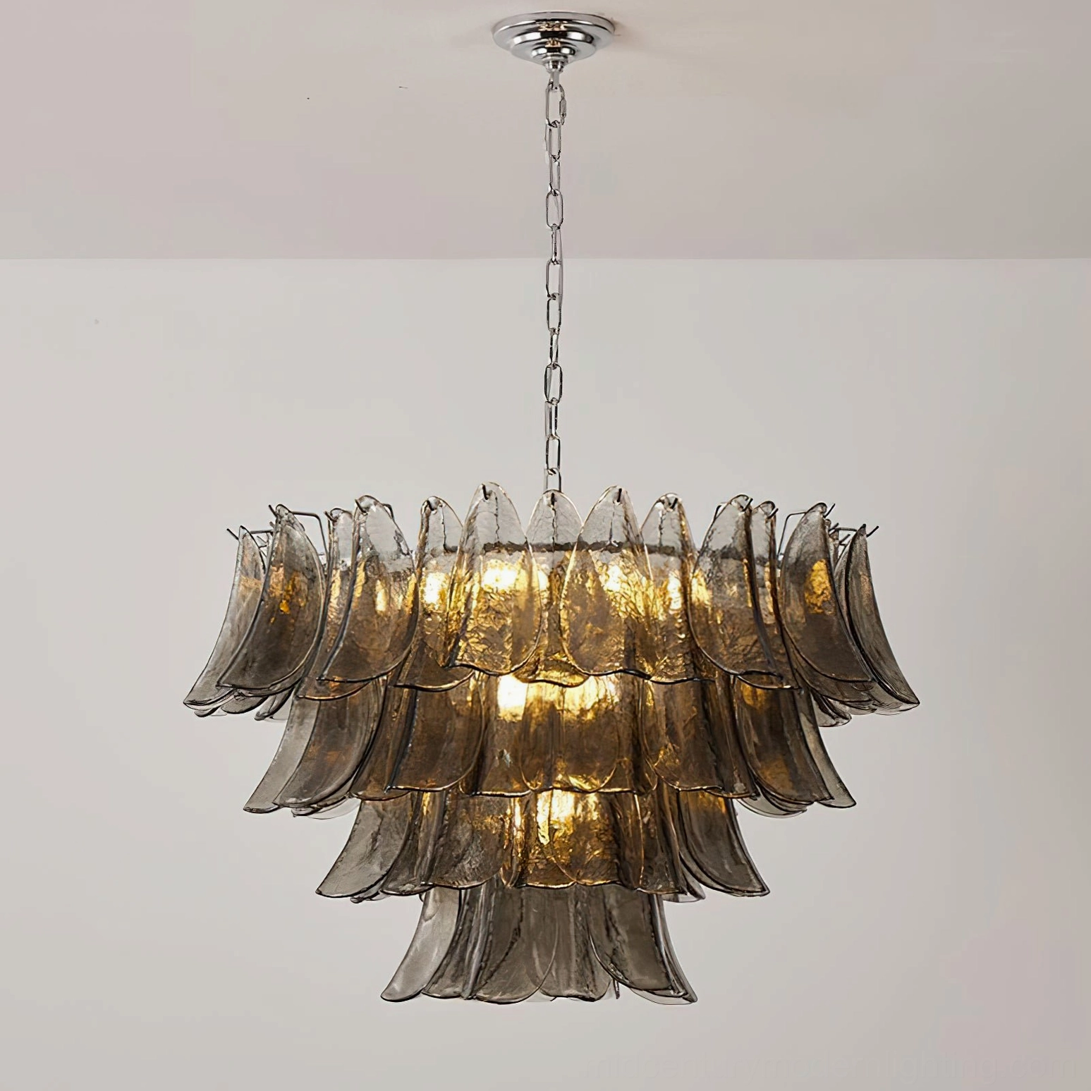 Vivienne chandelier installed ceiling view illuminated with warm glowing light and chrome suspension chain